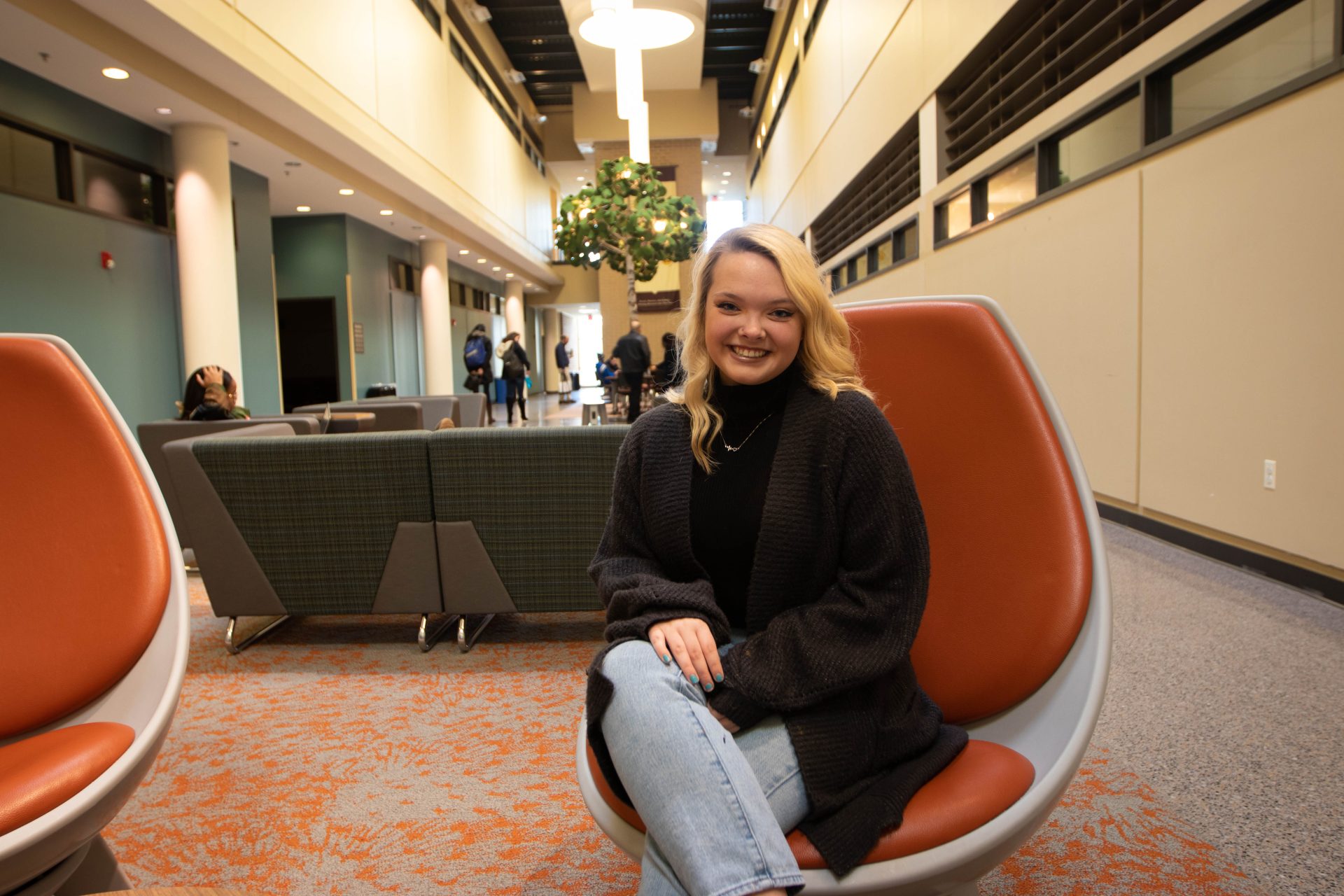 Molly sitting in James Halls second floor lounge.