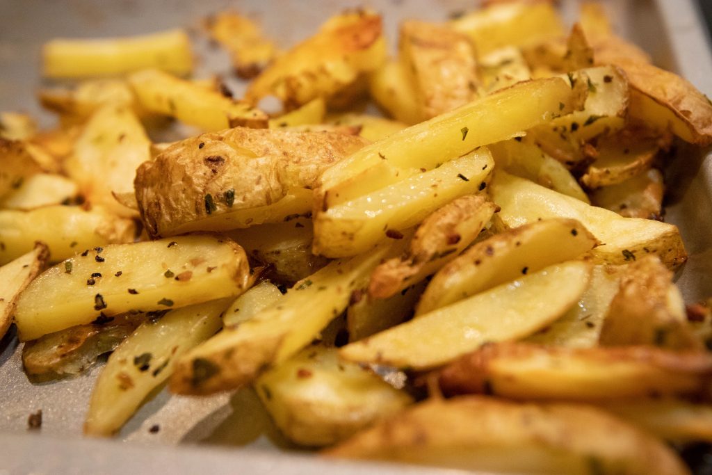 Baked fries on a cookie sheet.