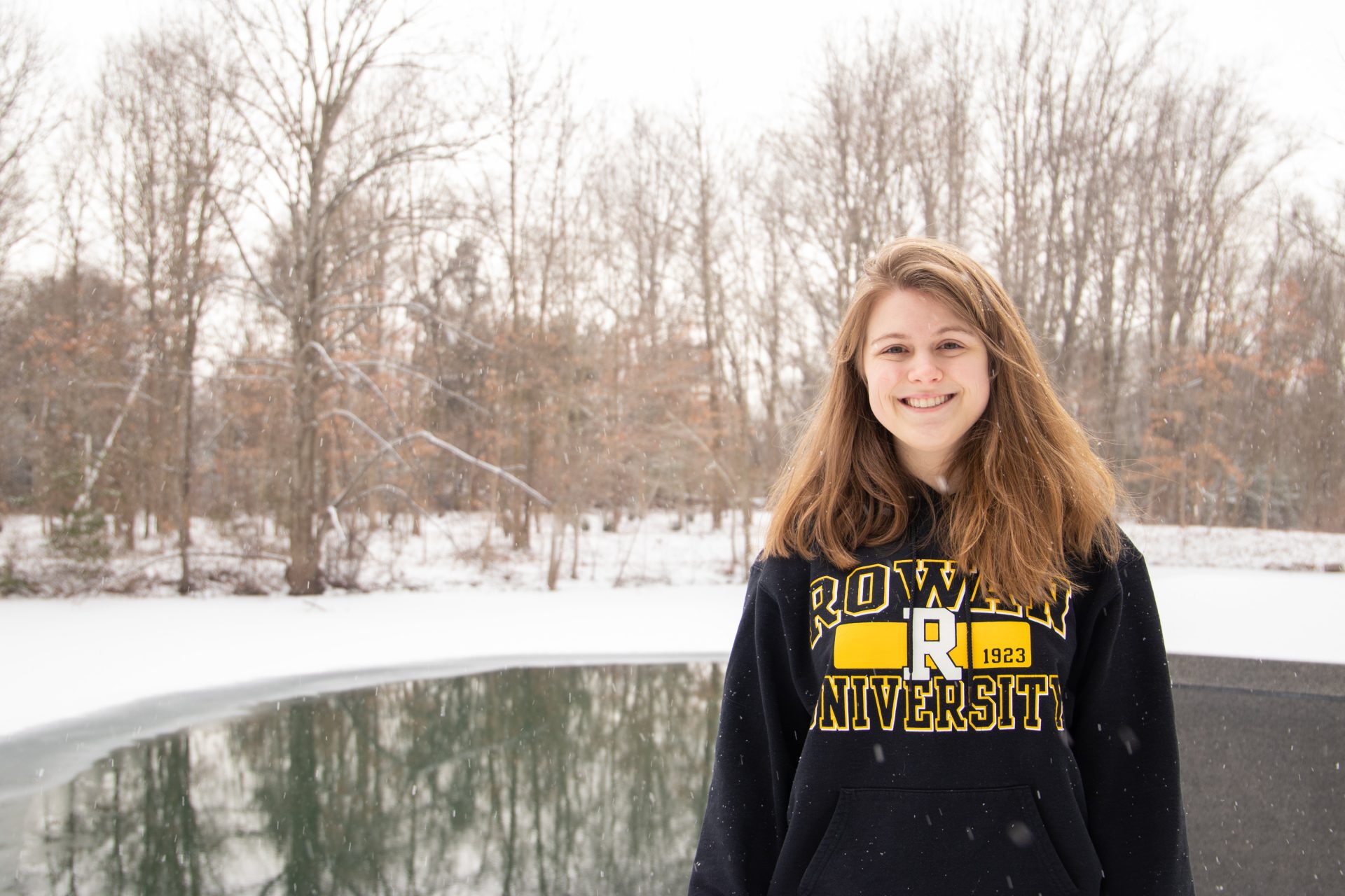 Morgam Dean posing in front of the pond in back of the Engineering building.