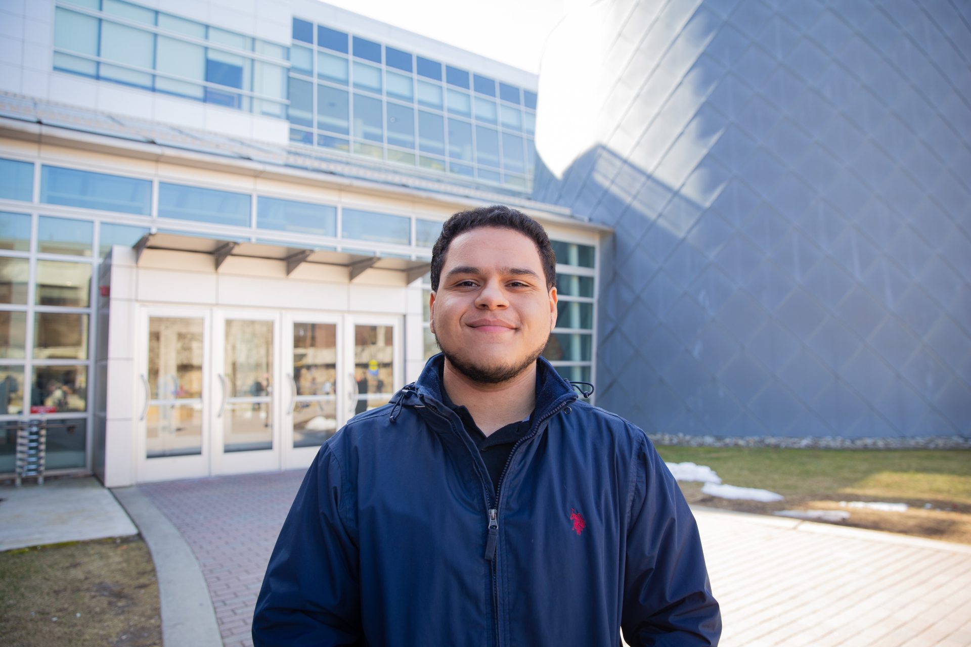 Luis Acevedo posing outside the science building at Rowan University.