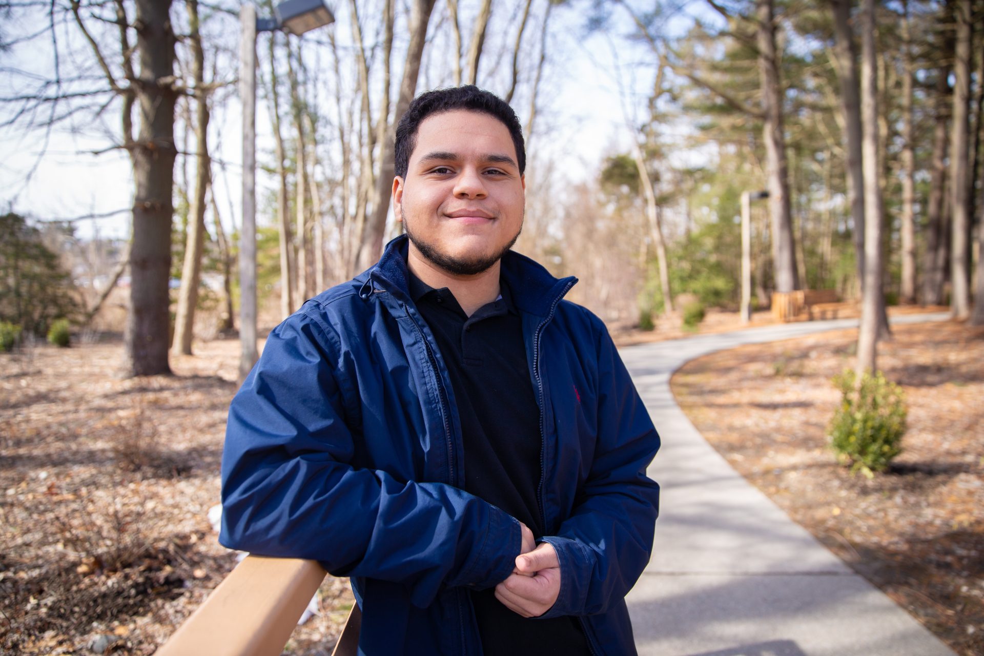 Luis Acevedo posing on the bridge behind the Engineering building at Rowan University.