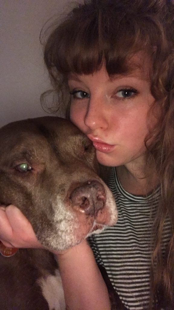 Kayla and her dog posting together