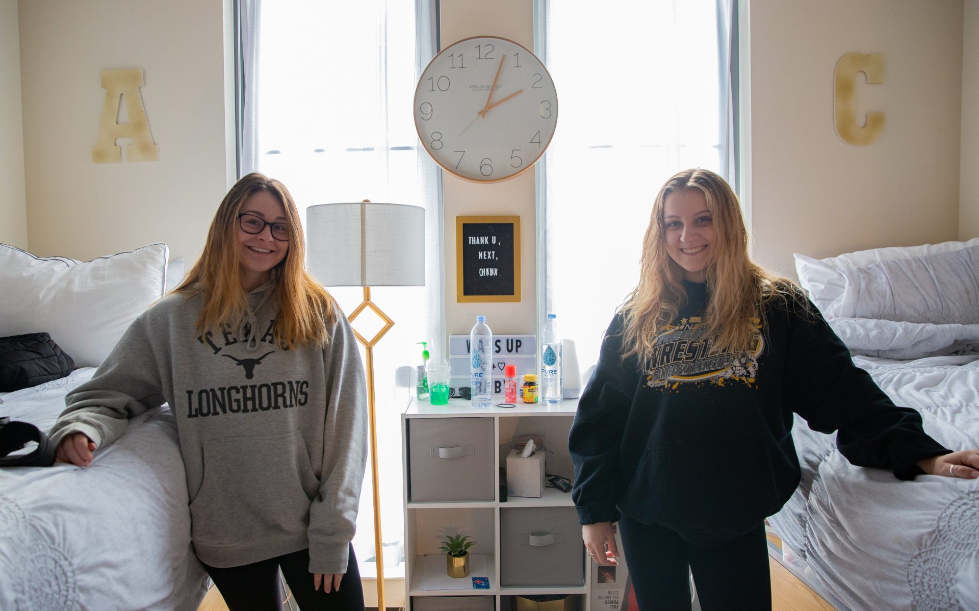 Carli and Alayna posing in their dorm in Holly Pointe Commons.