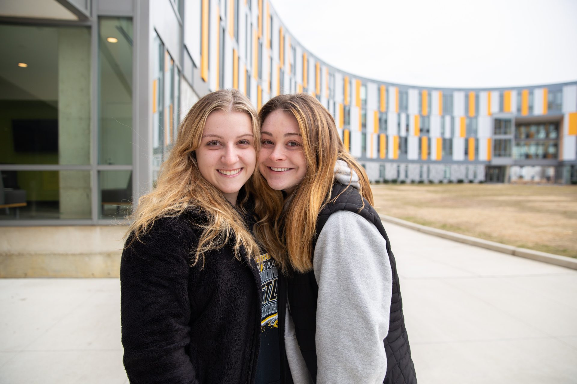 Carli and Alayna posing outside of Holly Pointe Commons.