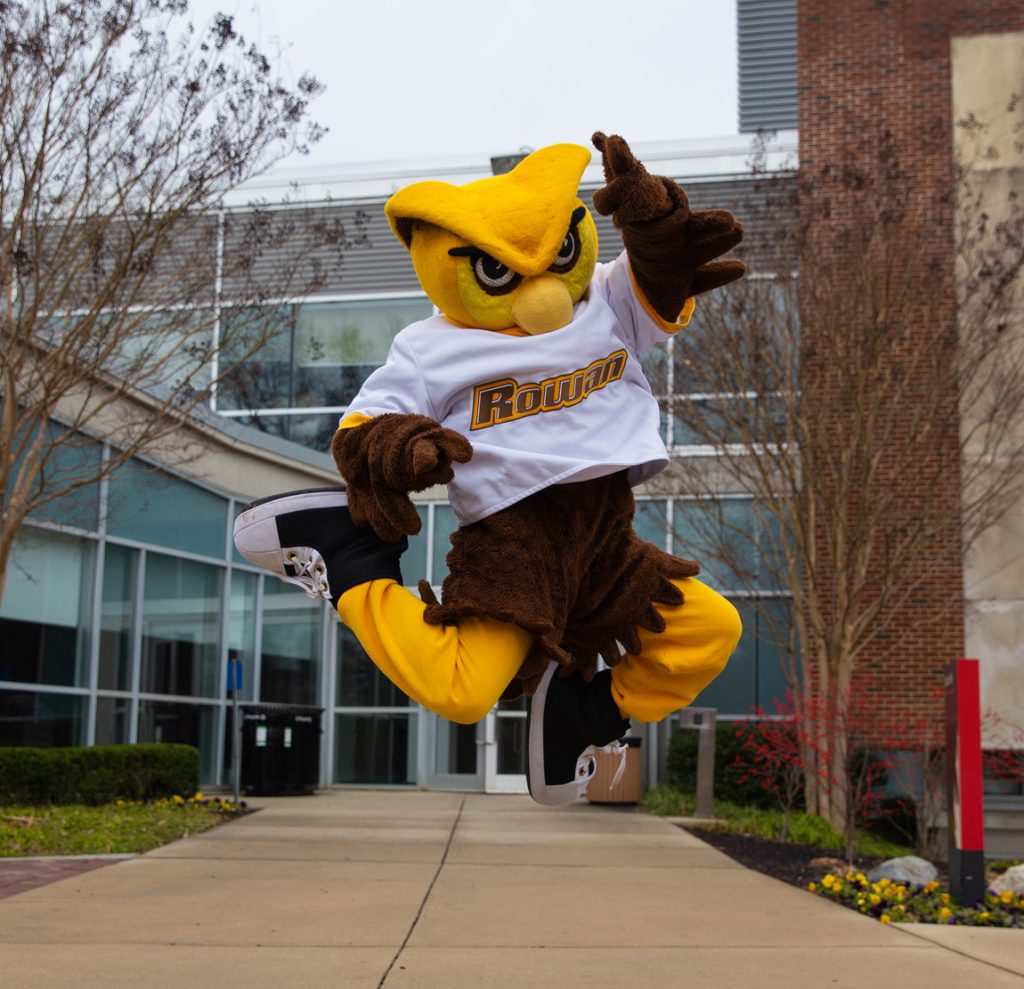 Mascot Whoo RU jumps for joy outside of Savitz Hall