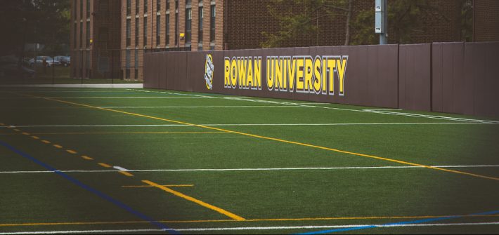 Rowan University sign showing on the athletics field