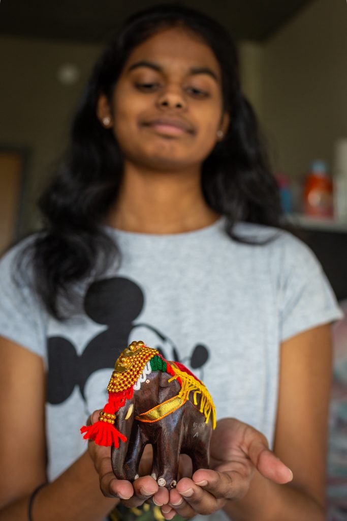 Prasheetha holding an elephant collectible from India from her mom 