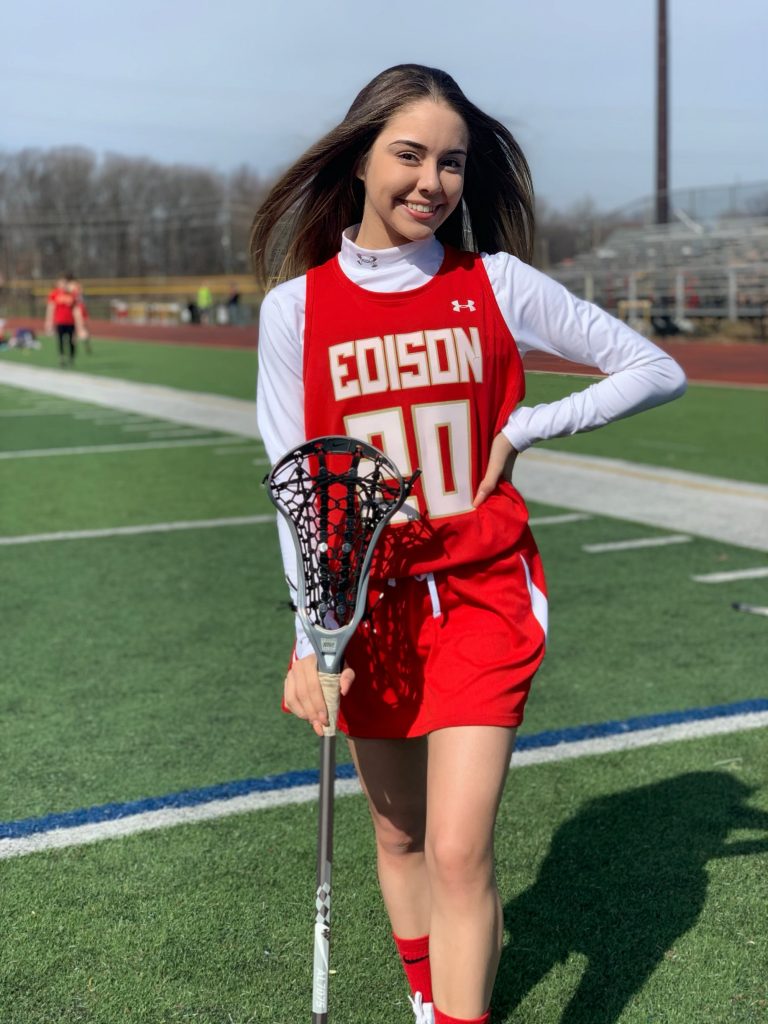 Ariana in her lacrosse uniform on the field.