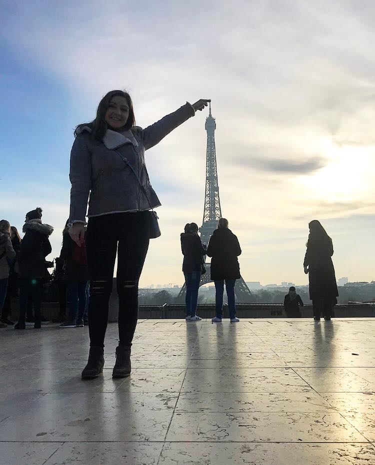 Brianna "touching" the top of the Eiffel Tower in Paris, France during her winter abroad trip in 2017.