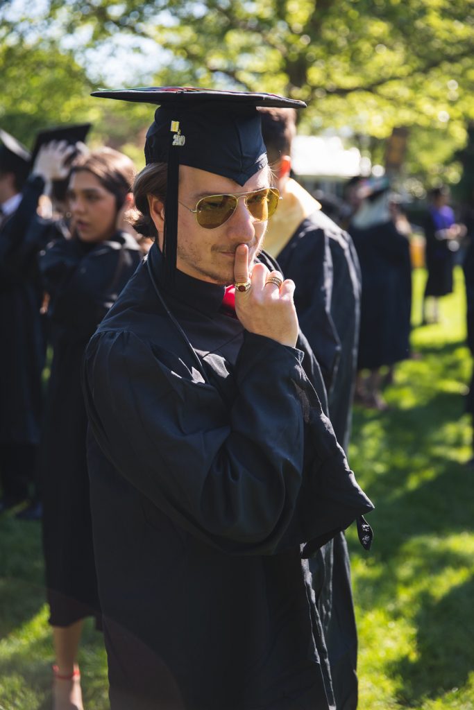 Graduate Taylor Forte poses in his black cap and gown.
