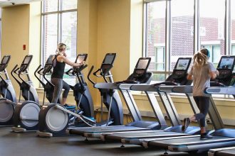 Several students working out on treadmills in a fitness center