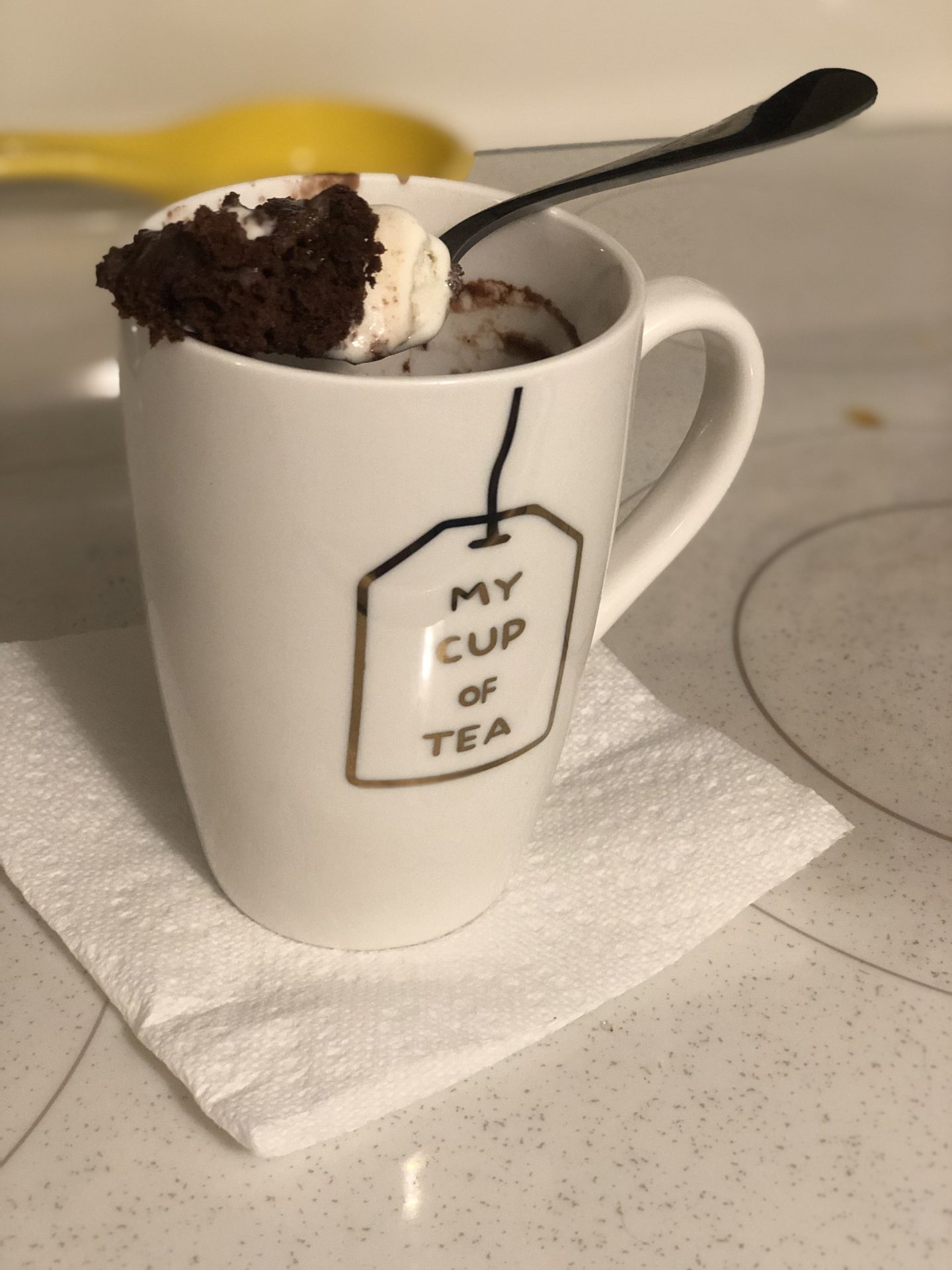 the finished dessert - chocolate and whip cream poking out of the mug