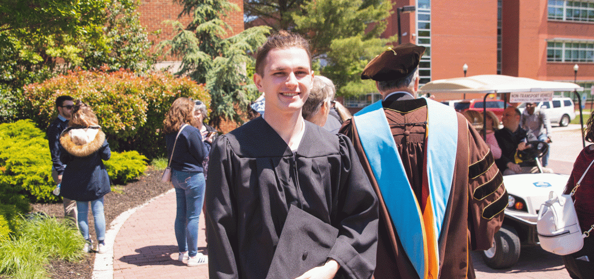 Rowan graduate standing outside after commencement