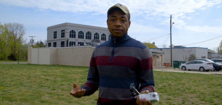 Rashaun Brown stands outside in the vacant lot.