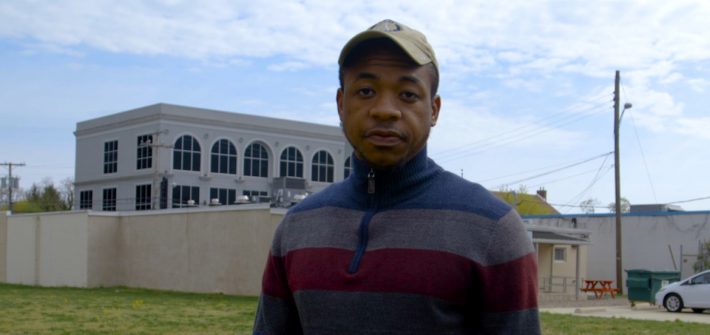 Rashaun Brown stands outside in the vacant lot.