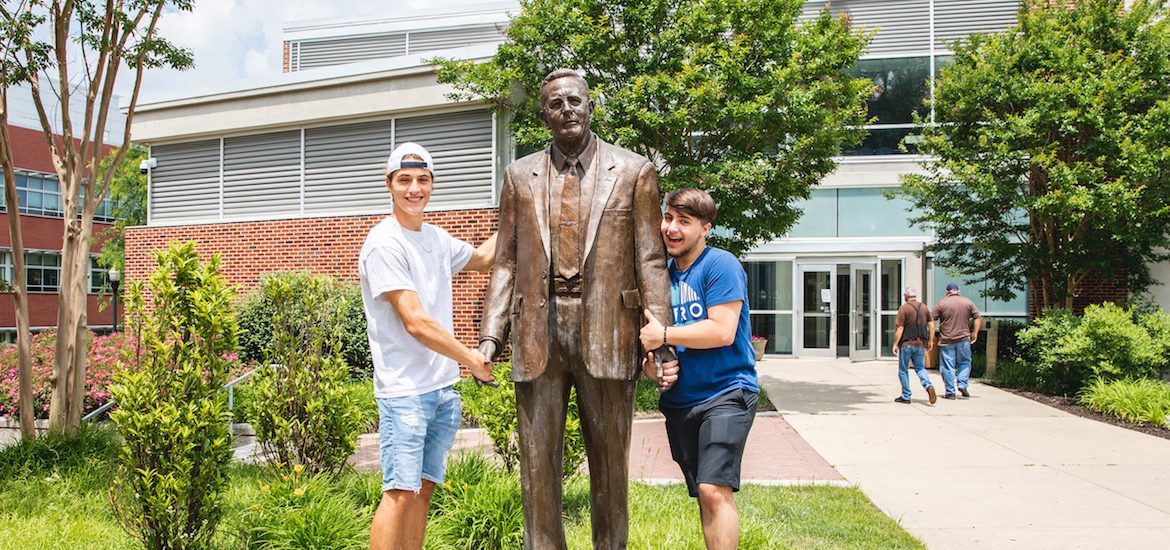 Dillon Weigand and Chase Weigand, new freshmen at Rowan University, pose in a silly way with the Henry Rowan statue