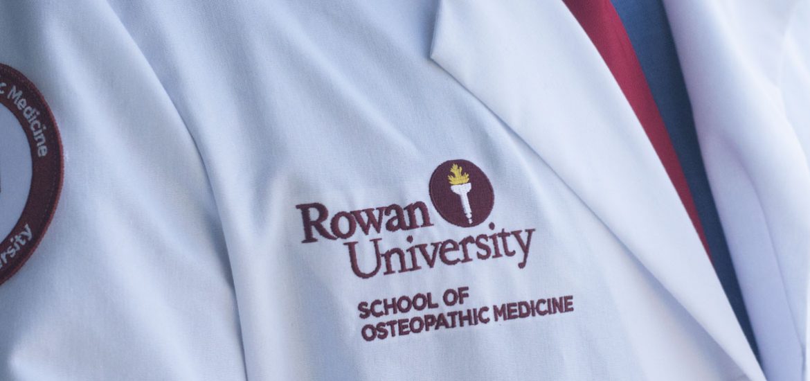 Lab coat of Nathan Carroll labeled "Rowan University: School of Osteopathic Medicine"