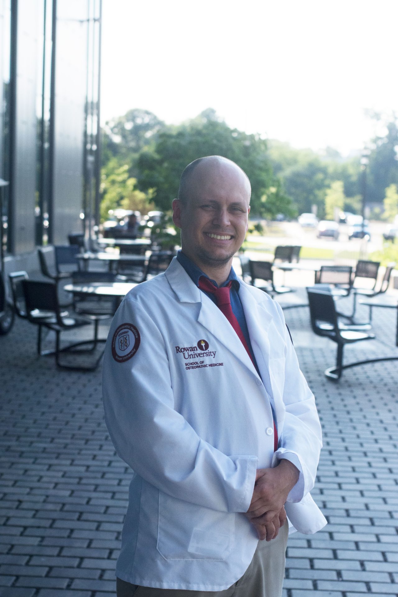 Nathan Carroll standing outside of the Business Hall on Rowan's main campus