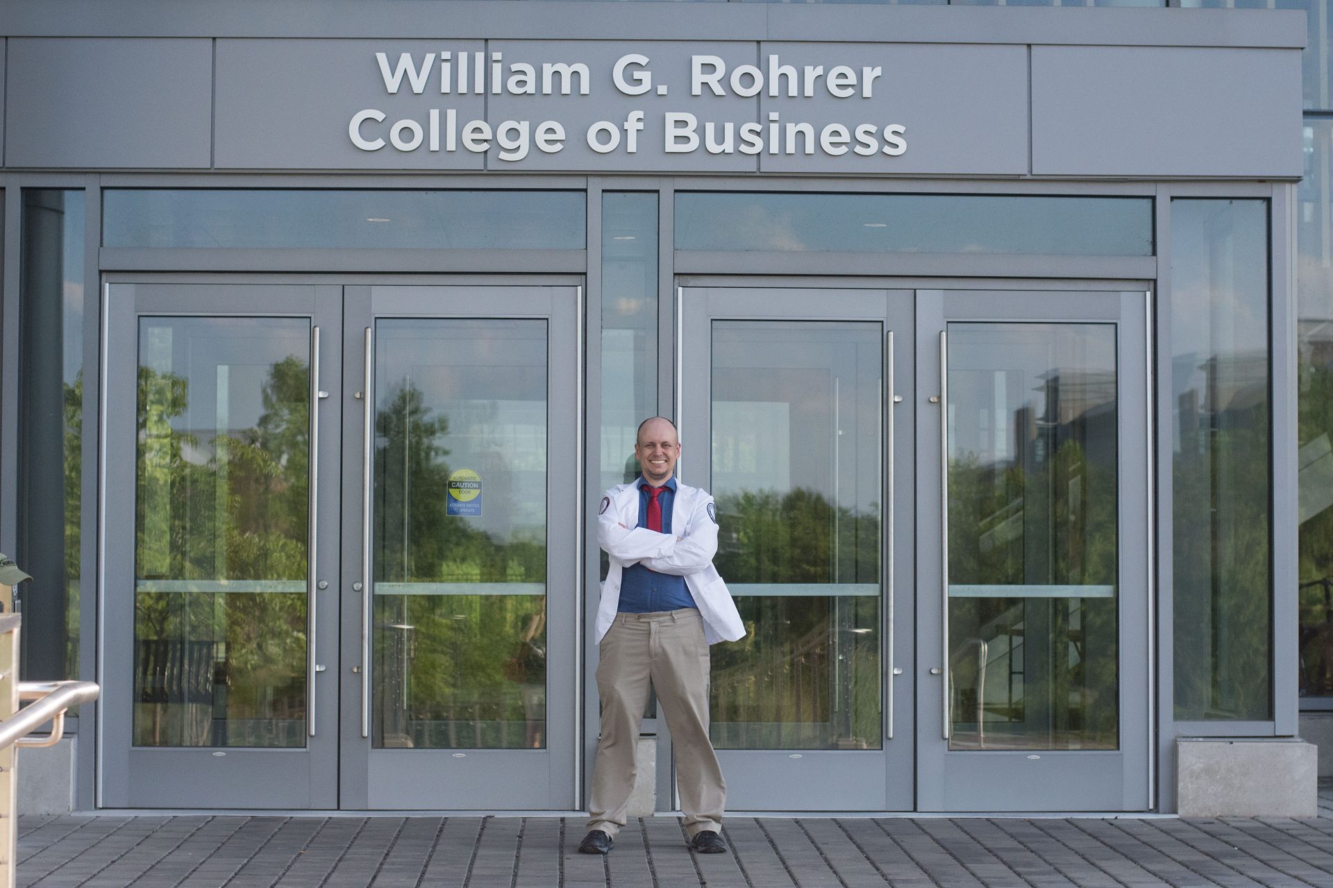 Rowan MBA alumnus and medical student Nathan Carroll outside the entrance of Business Hall