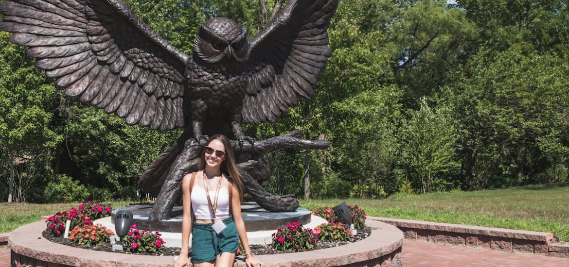 Ariana poses in front of the Rowan Owl statue.