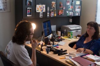 Professor Quigley and a student sit in her office during a meeting