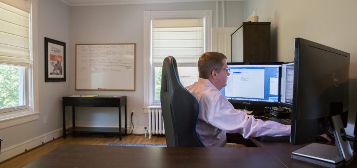 Steve McKeon working on his desktop computer in his home office