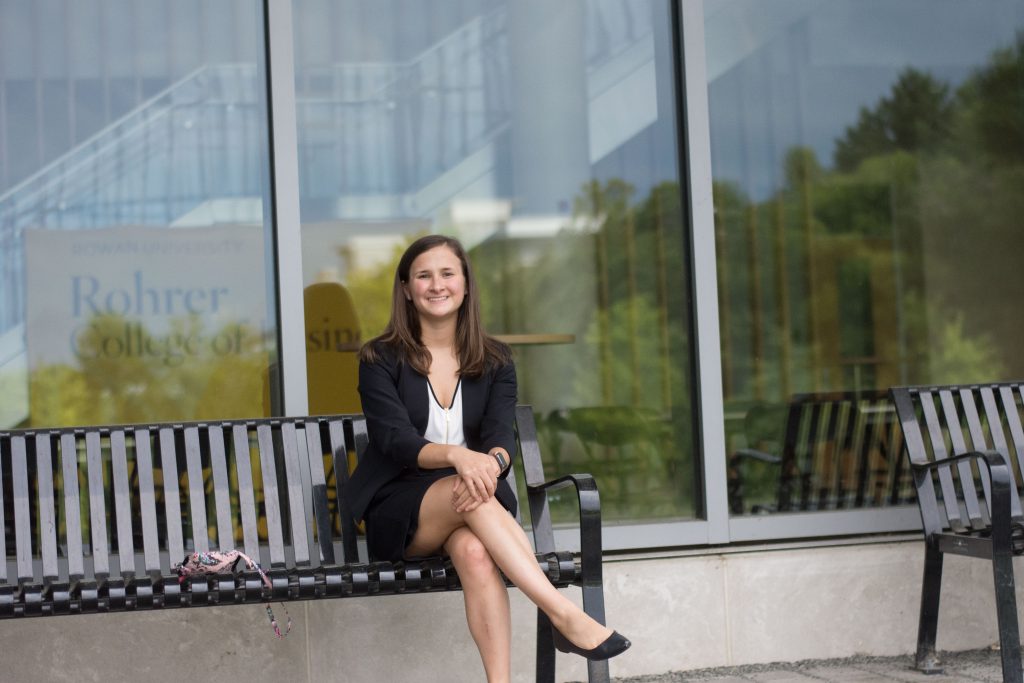 Rowan student Melissa Kolaski sitting outside of the Business Hall on campus