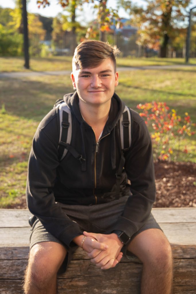 Michael Milevoi, a Finance major and Rowan freshman, sits on a paver bench