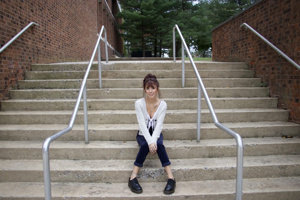 Psychology major Gwyneth Blackley sits on steps on Rowan's campus