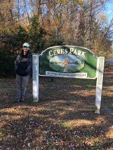 Jack stands by the sign for Ceres park.