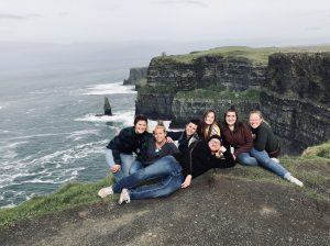 Leann and her friends posing at the Cliffs of Moher, Ireland