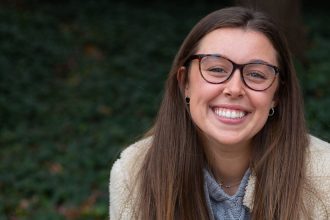 Biology major Roxy Urso sitting on a campus bench