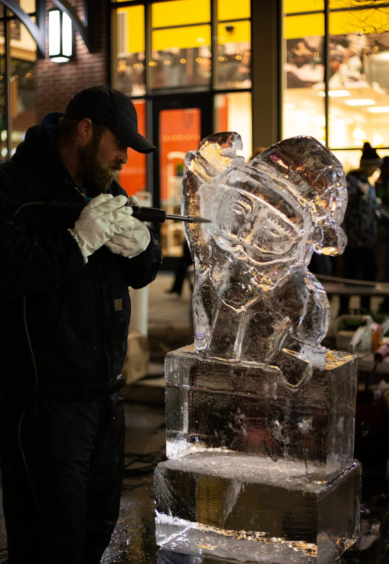 Santa being sculpted in the middle of Rowan Blvd.