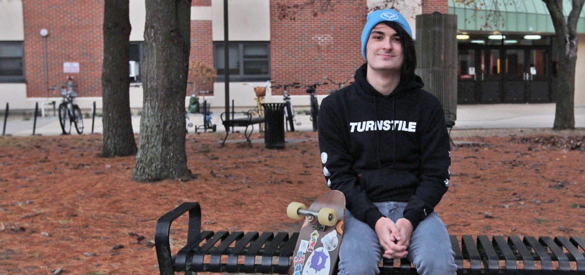 Freshman Music Industry major Devin Saienni sits on a bench on campus