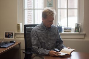Professor Matthew Lund reads from a philosophy book