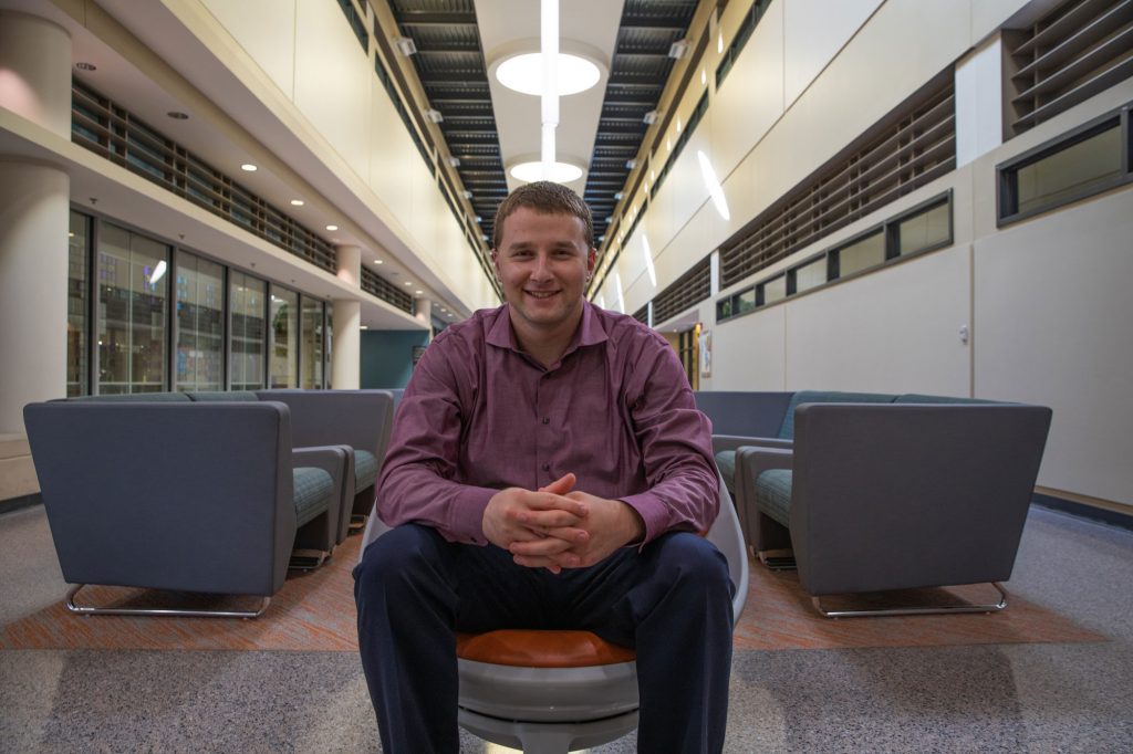 Wide shot of Ben Wilner on the first floor of James Hall