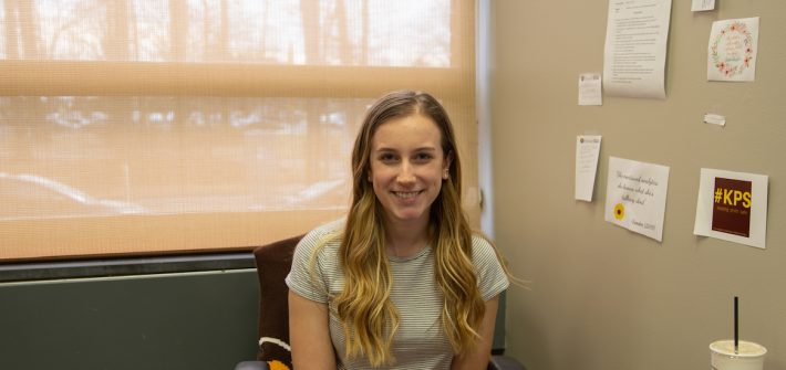 Cam sits in her office in the Student Center.