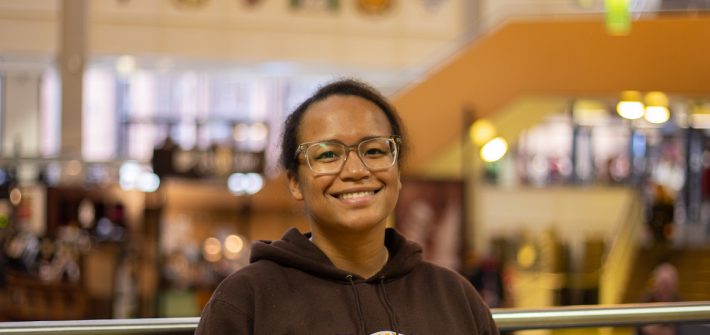 Autumn smiles at the camera for a portrait taken in the student center.