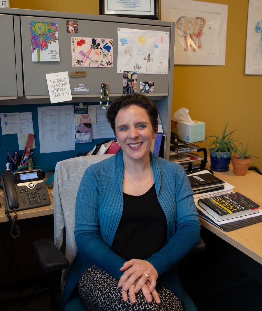 Dr. Mallouk sits at her desk in Rowan Hall.