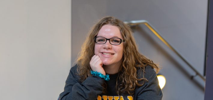 Autumn smiles in the lobby of Savitz Hall.