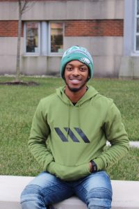 RTF student sitting outside the library 