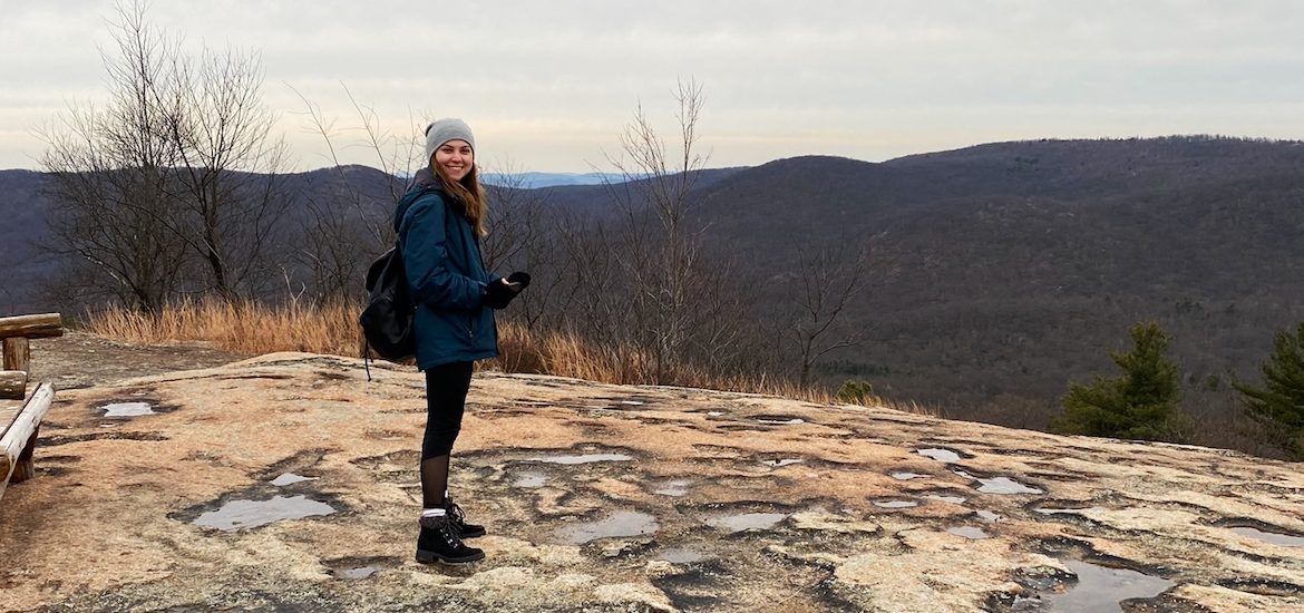 Alyssa Bauer poses at the top of Bear Mountain, NY.