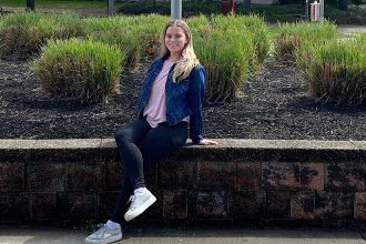 a photo of julia sitting outside the Rec Center