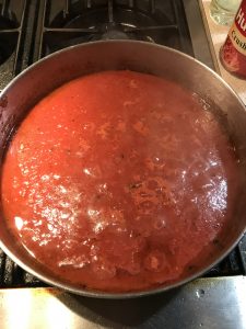 Added crushed tomatoes to the pan. 