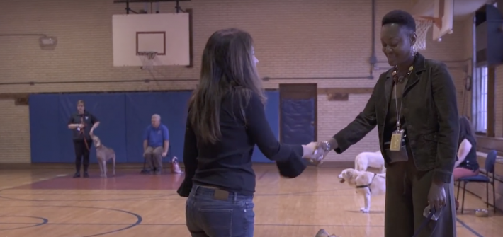 Rosetta shaking hands with another dog trainer.