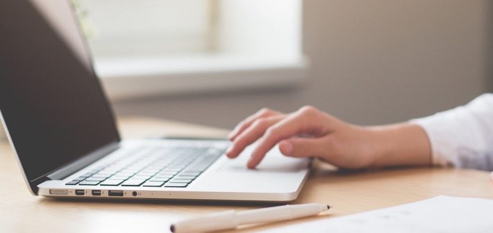 Stock image of woman hand working on a laptop.