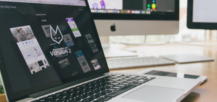 Stock image of a laptop at a home work station.