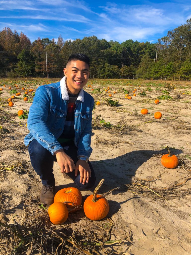 Justin posing with pumpkins.