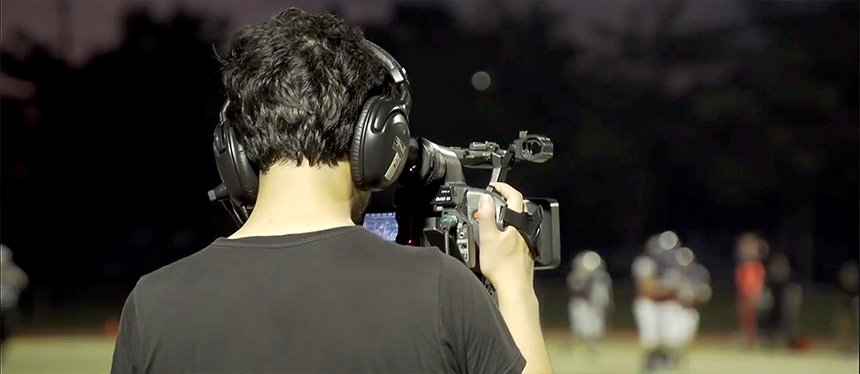 A cameraman films an athletic event