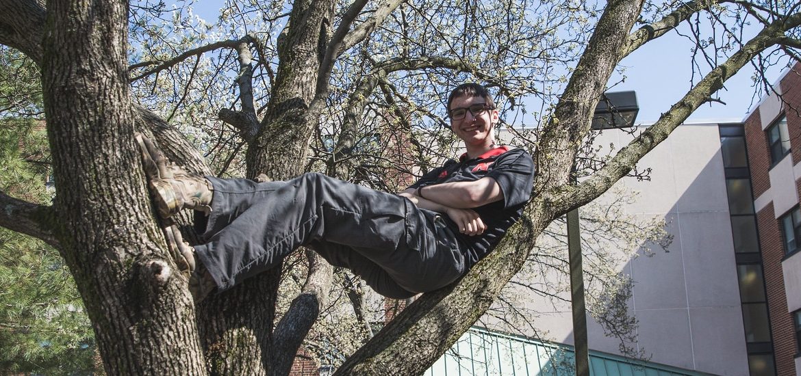 Troy Becker in a tree on campus.